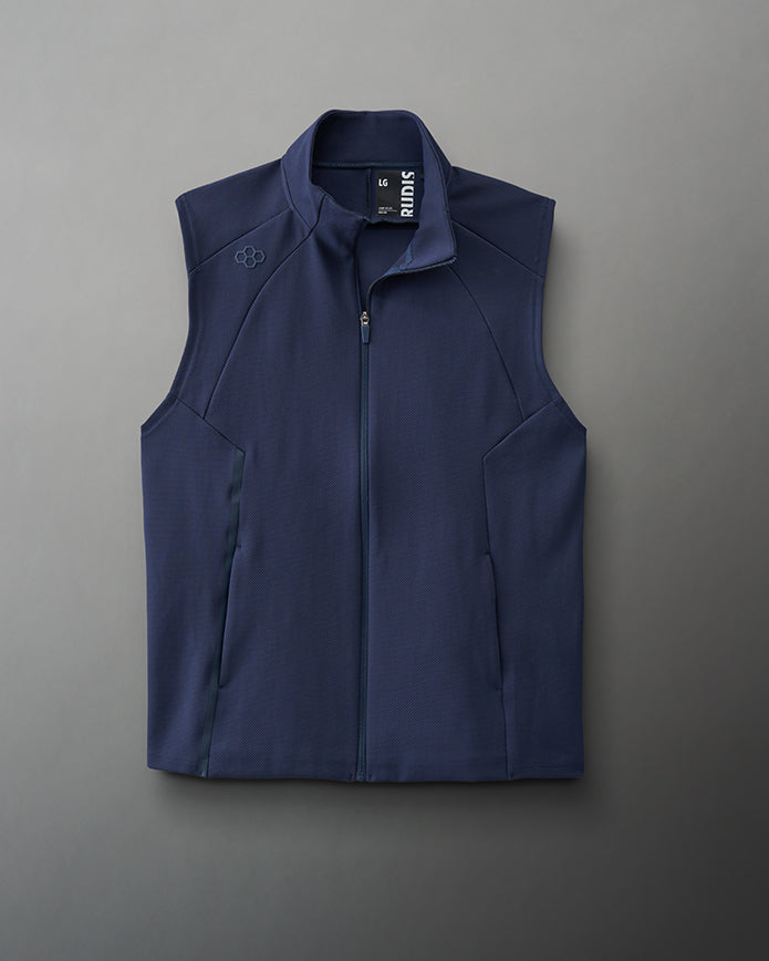 A navy blue sleeveless vest with a high collar, side pockets, and a breathable textured fabric, suitable for layering.